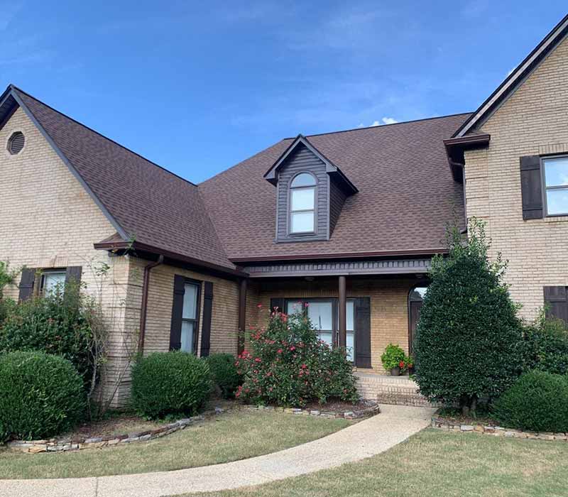 Front of home with new brown shingles installed by J & B Construction, LLC